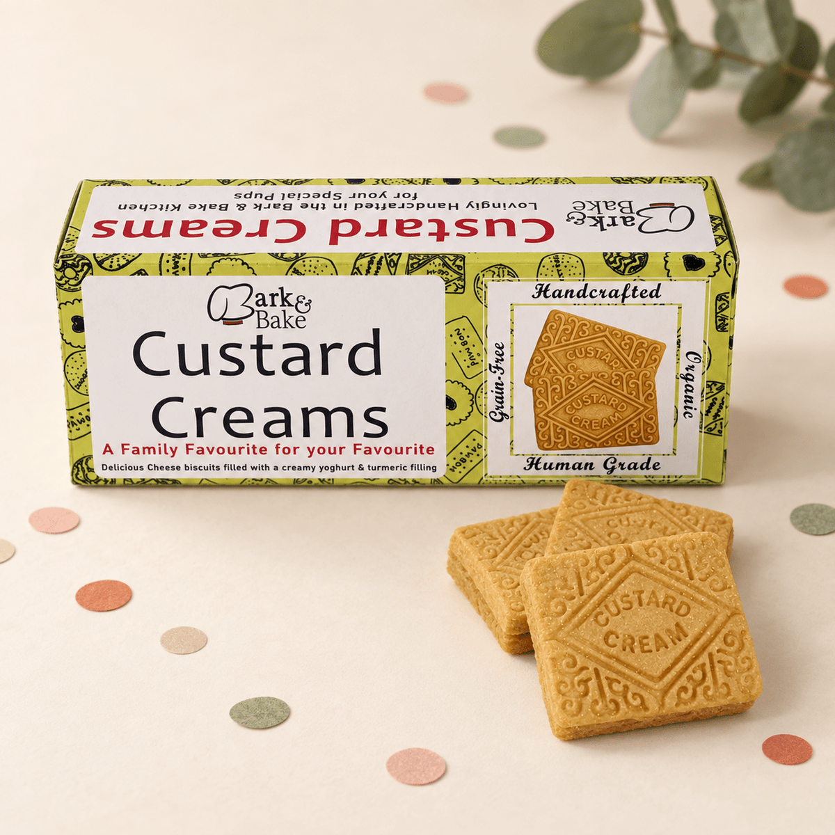 Barke Bake Custard Creams biscuit box with two square Dog Birthday Treat Box - golden-brown Custard Cream biscuits in front,